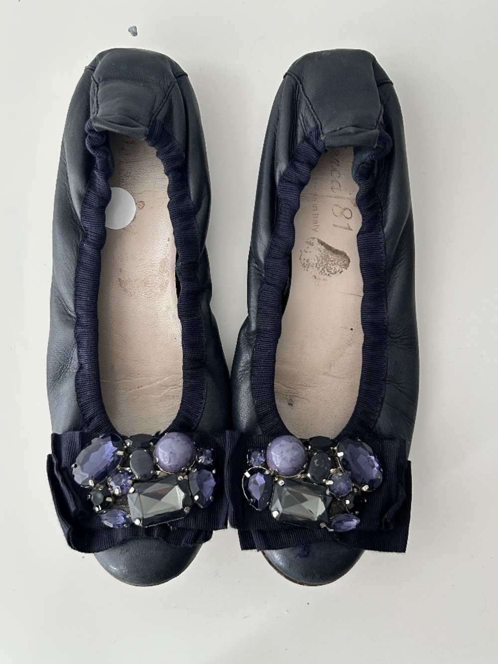 Blue leather ballet flats with bow and gems